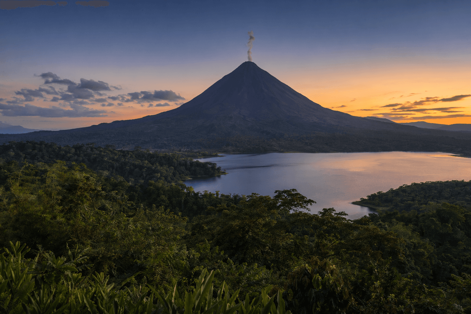 Arenal Volcano at sunset with Lake Arenal, Costa Rica